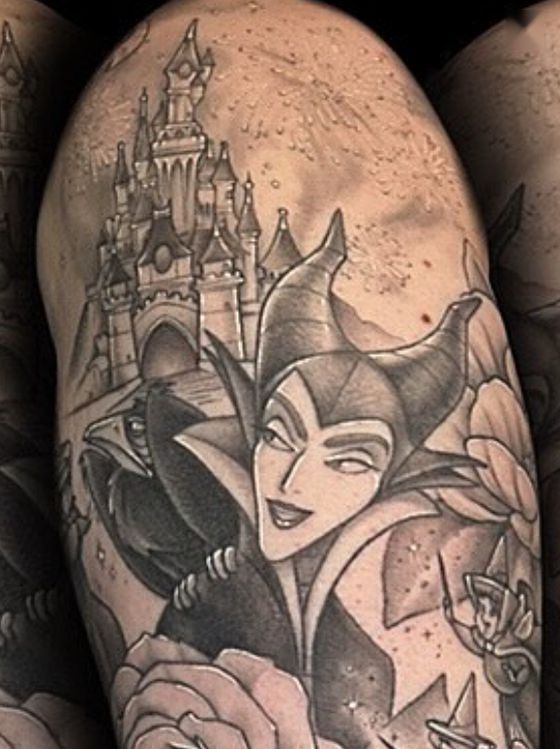 Black and grey castle and horned villainess tattoo on an upper arm