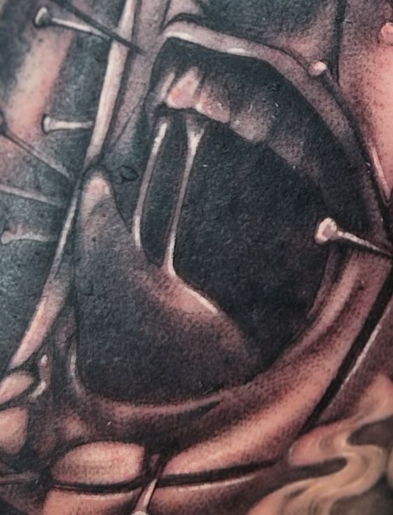 Black and grey open mouth with fangs and nails tattoo