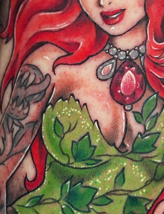 Color illustrated tattoo of a red-haired woman with a ruby pendant and leaves